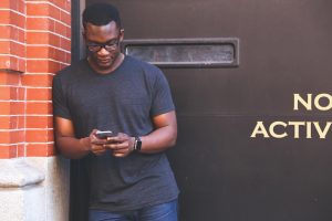 A person checking a business on their smartphone, the kind of quick mobile search a slow website can lose
