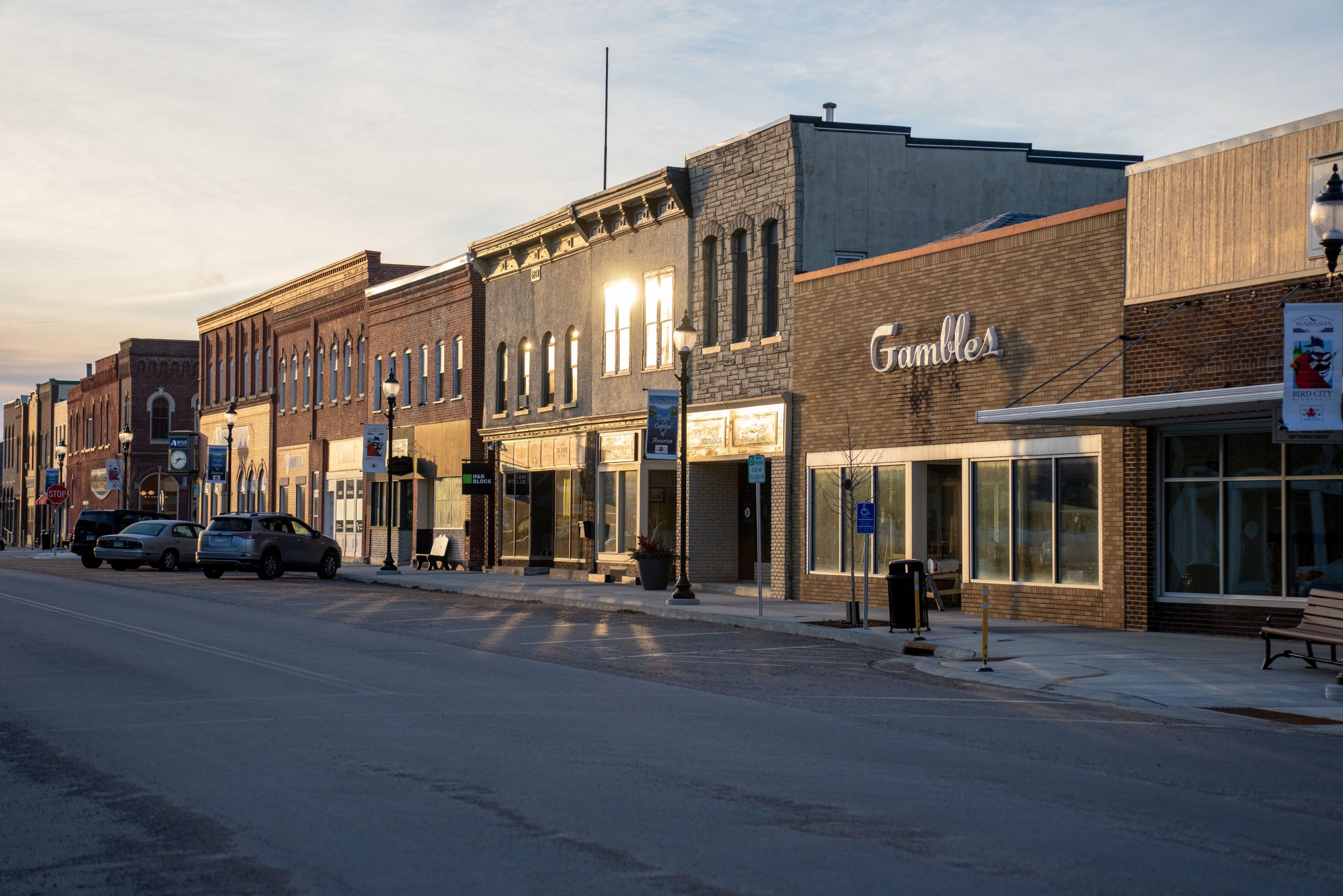 Small town main street lined with local storefronts at sunset, representing a service area across nearby towns