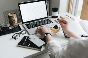 A laptop and tea on a home desk, where a past customer reads the email that brings them back