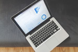 Laptop showing marketing analytics charts, illustrating how to track local ad performance and spend